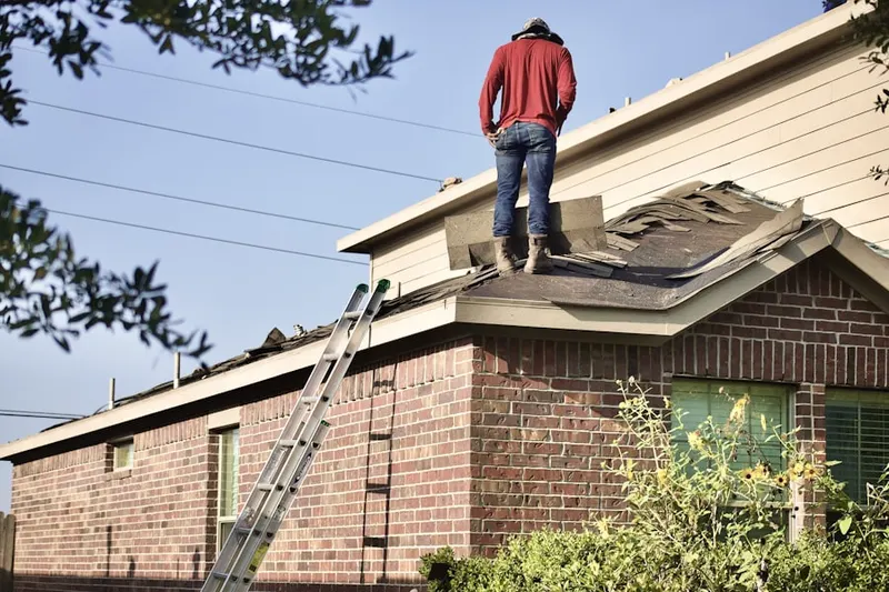 Professional roofer working on a residential roof in German Flatts